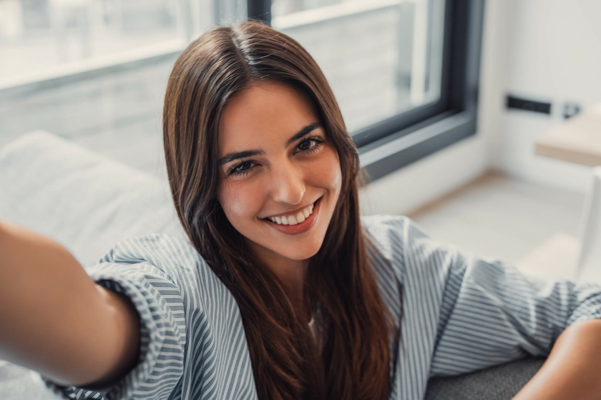 Happy woman at home taking a selfie